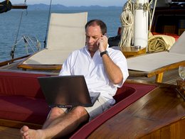 man-talking-on-phone-from-boat